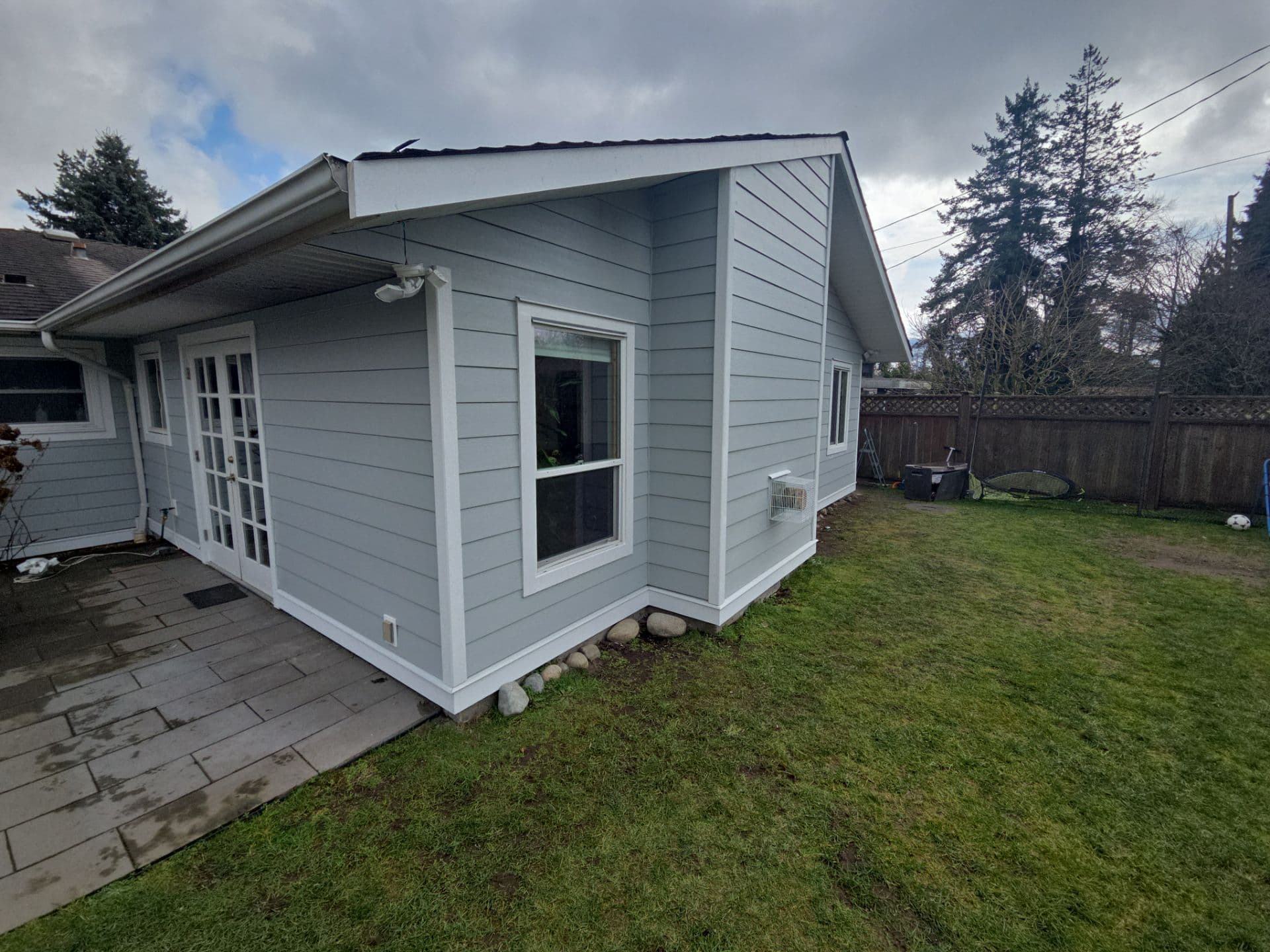 Hardie siding installation progress showing weather barrier by Tomron Construction in Maple Ridge, BC