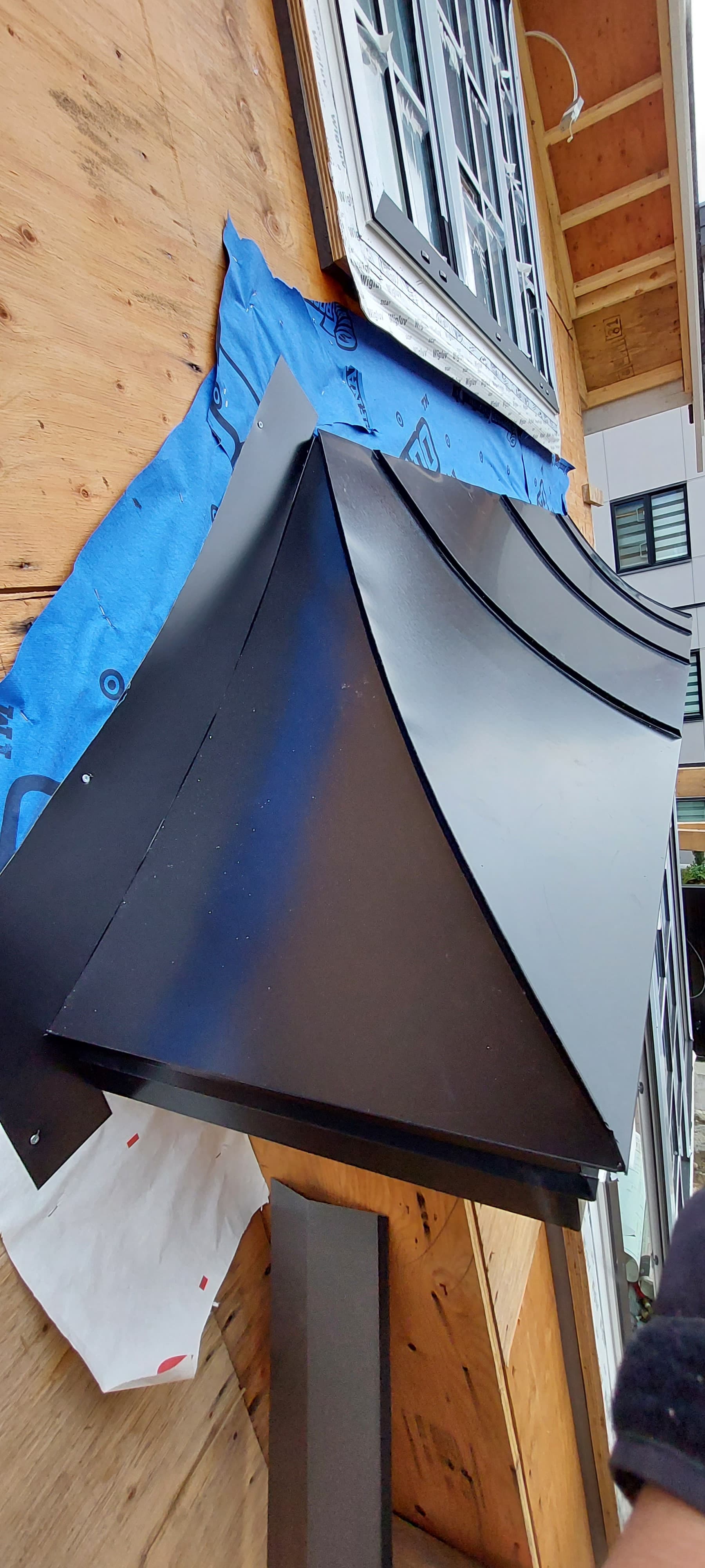 Z-bar metal flashing between siding courses by Tomron Construction in Maple Ridge, BC